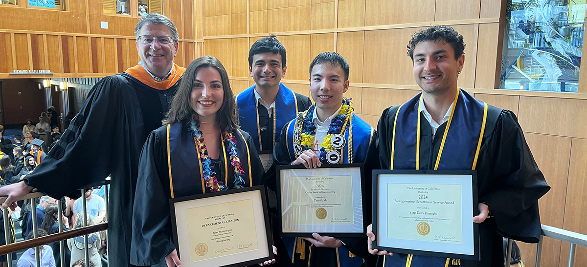 photo of departmental award winners with their certificates and Chair Messersmith on the stairway landing of the Stanley Hall atrium at the 2024 Bioengineering commencement reception