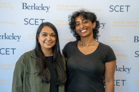 photo of Gurram and Patel in front of Berkeley SCET banner