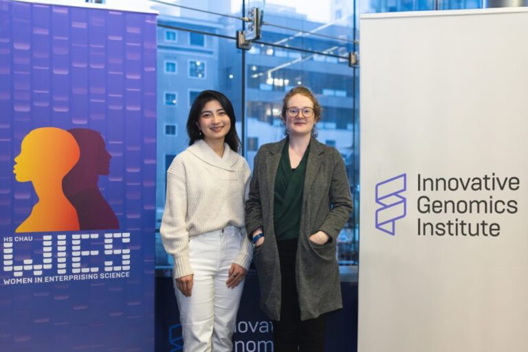 Clare Lou (left) and Derfogail Delcassian stand before a banner for the Innovative Genomics Institute