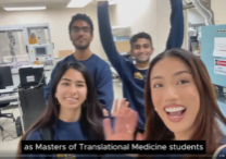 still frame from video of four MTM students waving in laboratory