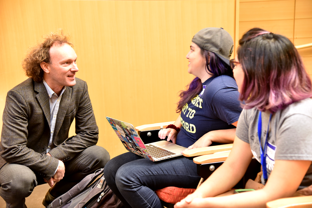 Professor Fletcher speaking to two students on Cal Day 2017