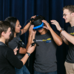 photo of students trying on VR headset